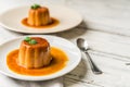 Close up of a flan creme caramel pudding with mint, a custard dessert. Royalty Free Stock Photo