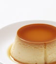 Close up of flan on white plate created using generative ai technology Royalty Free Stock Photo