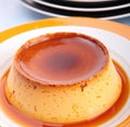 Close up of flan on white plate created using generative ai technology Royalty Free Stock Photo