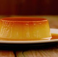 Close up of flan on white plate created using generative ai technology Royalty Free Stock Photo