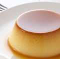 Close up of flan on white plate created using generative ai technology Royalty Free Stock Photo