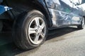 Close up of flat burst car tyre and damaged bodywork. Royalty Free Stock Photo
