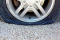 Close up on Flat Car Tire on Gravel Road Royalty Free Stock Photo