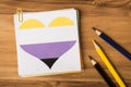 Close up flat lay photo of stack of notice paper office clip drawn heart with white yellow purple black colors and multicolored Royalty Free Stock Photo