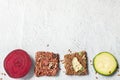 Close up flat lay top view crunchy flax seed crispbread with dry and raw vegetables on white background copy space