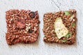 Close up flat lay top view two crunchy flax seed crispbread with dry vegetables on white background