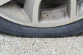 Close-up of Flat rear tire on car. The right rear broken weel. Damaged rear wheels on parking place Royalty Free Stock Photo