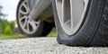 Close-up of Flat rear tire on car. The right rear broken weel. Damaged rear wheels on parking place Royalty Free Stock Photo