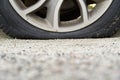 Close-up of Flat rear tire on car. The right rear broken weel. Damaged rear wheels on parking place Royalty Free Stock Photo