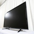 Close-up of a flat-screen TV against a white backdrop isolated on white background Royalty Free Stock Photo