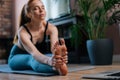 Close-up of flexible redhead young woman working out, doing stretching exercise on yoga mat Royalty Free Stock Photo