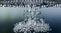Close-up of floating bubbles in water with reflective surface and dynamic movement Royalty Free Stock Photo