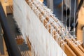 Close-up of a floor loom warp threads and heddles for textile weaving Royalty Free Stock Photo