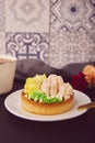 Close up of floral french tart with flowers. Pink floral cake, sugar free. Hygge home aesthetic. Ceramic tile background