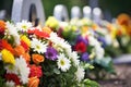 close-up of floral wreaths on a fresh grave