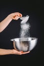 Flour sifting through a sieve for a baking Royalty Free Stock Photo