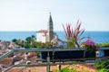 Close-up of a flower pot with St. George`s Parish Church and the Adriatic Sea at the background, in Piran, Slovenia Royalty Free Stock Photo