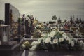 Close up of flowers on a graves at cemetery. Tombstone decoration, Funeral concept. All Saints` Day