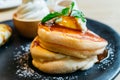 Close up Fluffy pancakes served with caramel banana, ice cream and syrup