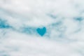 Fluffy white clouds patterns with bright blue heart shaped on sky for natural background Royalty Free Stock Photo