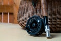 Close up of fly fishing rod with reel next to braided basket. Fly fishing equipment still life. Nobody Royalty Free Stock Photo