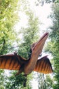 Close-up of a flying pteranodon dinosaur. Full length animatronics made of rubber and metal. The concept of restoring historical