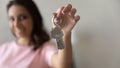 Close up focus on keys in happy Arabian woman hand