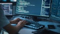 Close-up Focus on Person's Hands Typing on the Desktop Computer Backlit Keyboard. Screens Show Royalty Free Stock Photo