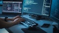 Close-up Focus on Person's Hands Typing on the Desktop Computer Illuminated Keyboard. Screens Royalty Free Stock Photo