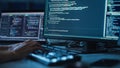 Close-up Focus on Person's Hands Typing on the Desktop Computer Illuminated Keyboard. Screens