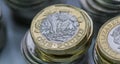 Close up focus photos of new United kingdom Pound coin, among other British coins