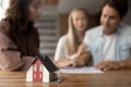 Close up focus on small house model standing on table. Royalty Free Stock Photo