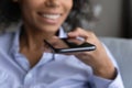 Close up african woman recording voice message. Royalty Free Stock Photo