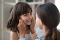 Mother play touch little adorable daughter at home