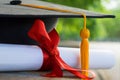 Close up focus of university graduate holds degree certificate and graduation cap celebrates in the  graduation ceremony. Royalty Free Stock Photo