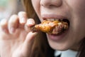 Close up focus woman hand hold fried chicken for eat