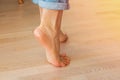 Close up focus on young female feet walking barefoot on clean wooden floor Royalty Free Stock Photo