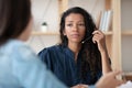 Close up focused african american businesswoman listening new female applicant. Royalty Free Stock Photo