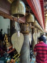 Golden metal bells in the exterior of Buddhist Temple in Bangkok, Thailand.