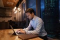 Close up focused businessman using laptop in office at night