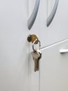 Close up focused on Keys in an office cabinets lock Royalty Free Stock Photo