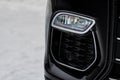 Close up fog light of the modern black car. Car front bumper with led headlight light. Royalty Free Stock Photo