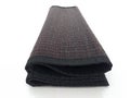 Close up of folded black placemats isolated. Perspective view of stacked black trivets on white background. Household items and