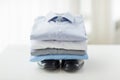 Close up of folded male shirts and shoes on table Royalty Free Stock Photo