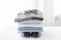 Close up of folded male shirts and shoes on table Royalty Free Stock Photo
