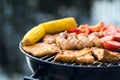 Close up of food grilling on a charcoal kettle grill Royalty Free Stock Photo