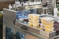 Close up food or various shape macaroni in multiple plastic box placed on automatic plastic film wrapping or protective packing Royalty Free Stock Photo