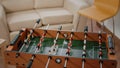 Close up of foosball game and bottles of beer with snacks on table