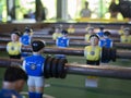 Close up of foosball game table plastic toy with blur of a family behide Royalty Free Stock Photo