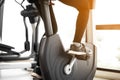 Close up foot biking in gym, exercising legs doing cardio workout cycling bikes